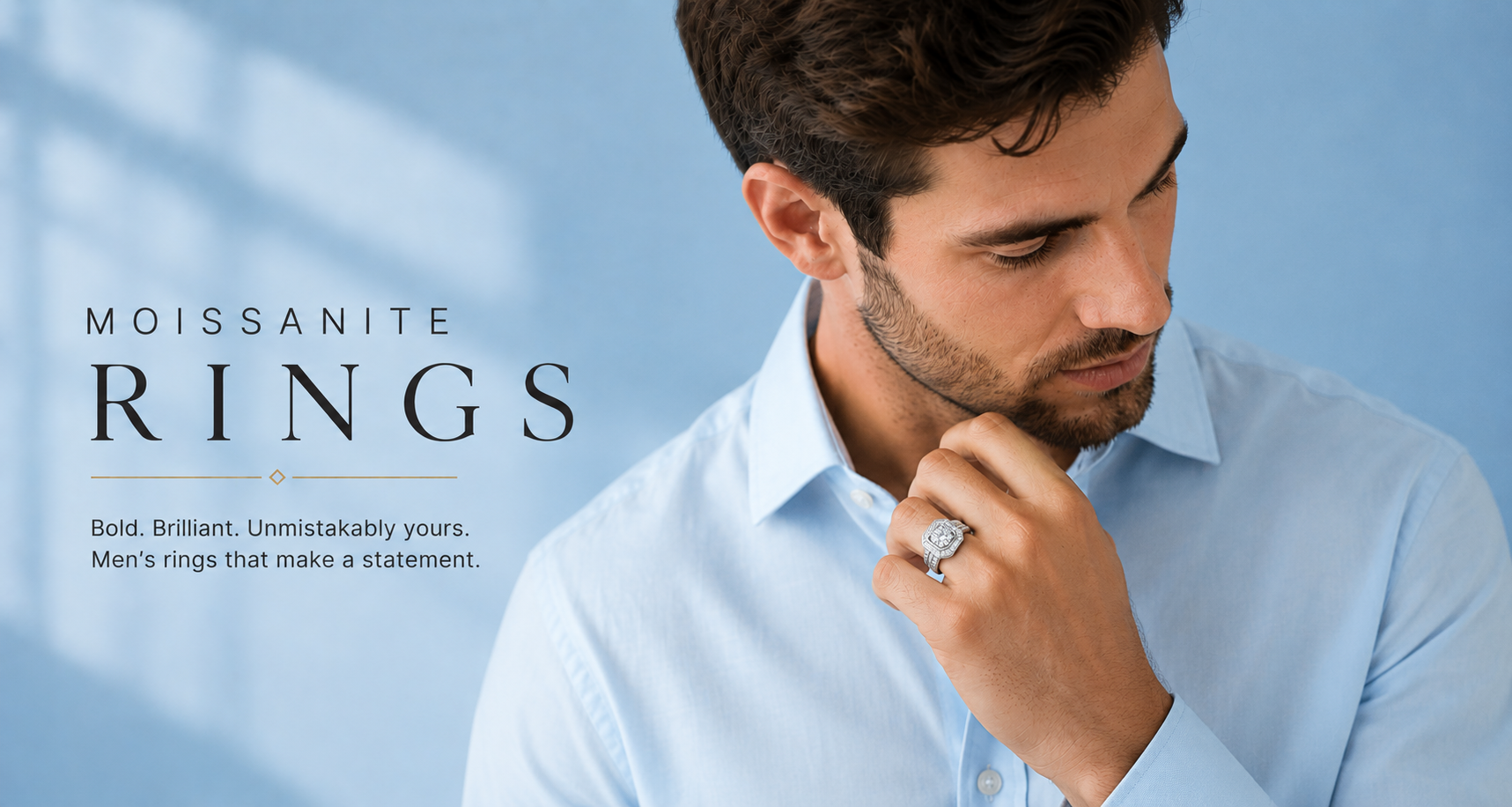 Man wearing a light blue shirt with a focus on Moissanite rings against a light blue background.
